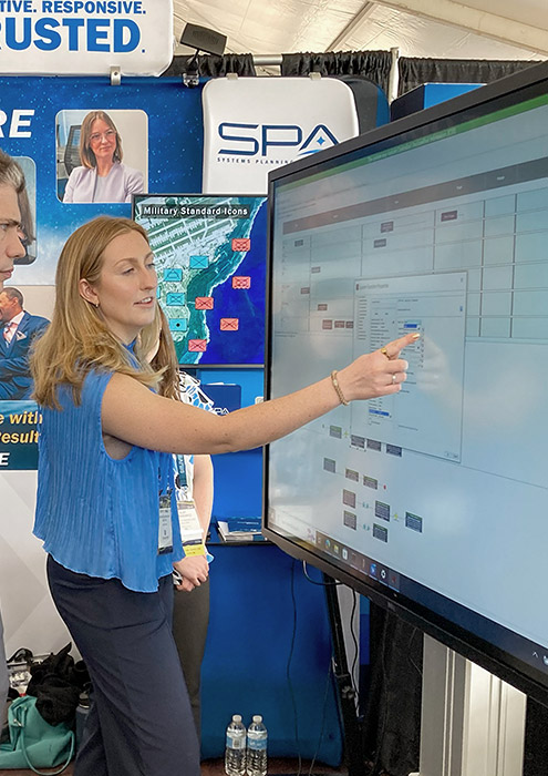An SPA employee demonstrates SPA's Athena, a user-friendly digital play surface for mission-planning table top exercises and wargaming