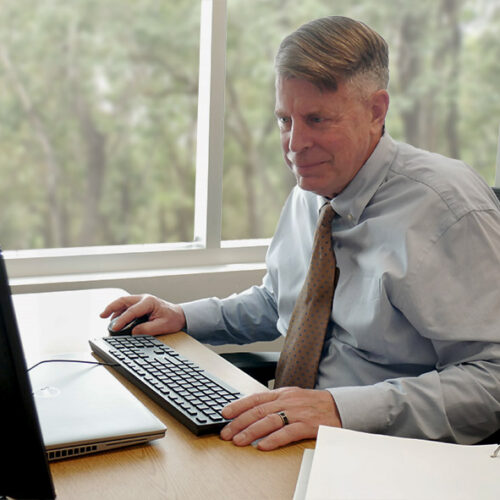 An SPA employee types at their desk